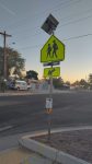 A street crossing with diamond crossing sign on the side of a street.